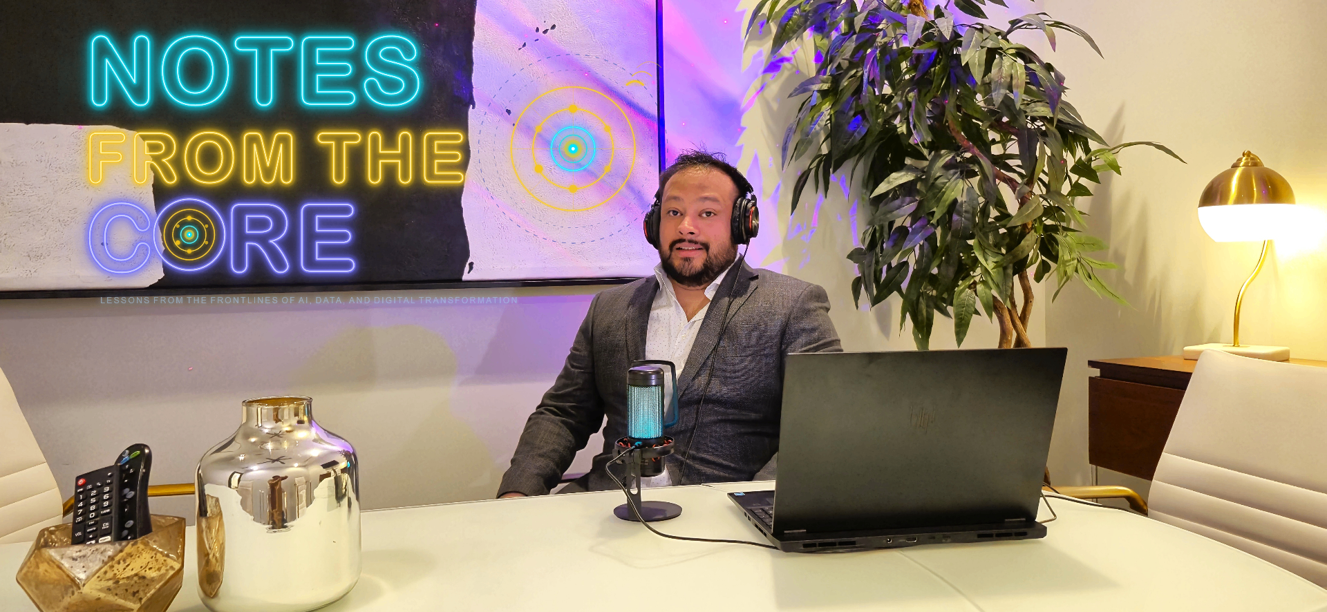 Host in studio with Notes from the Core neon sign